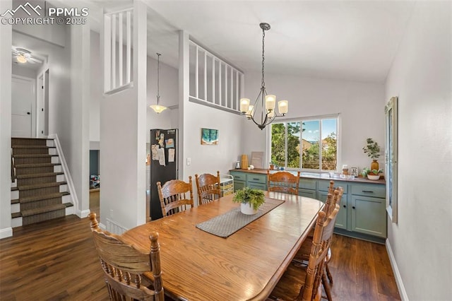 dining area featuring a chandelier, high vaulted ceiling, and dark wood-type flooring