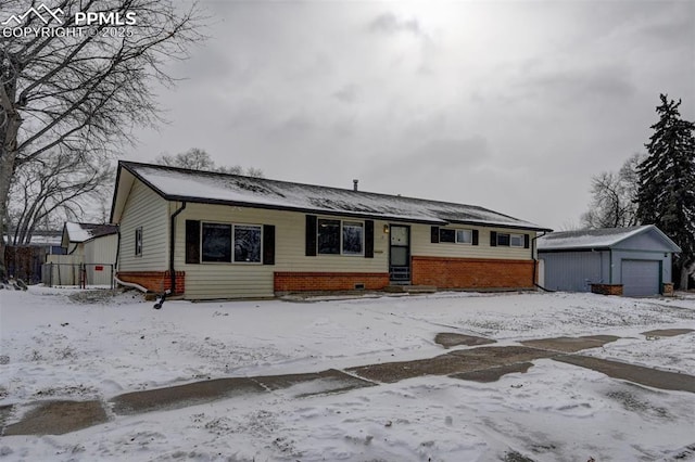 ranch-style home with an outbuilding, brick siding, and a detached garage