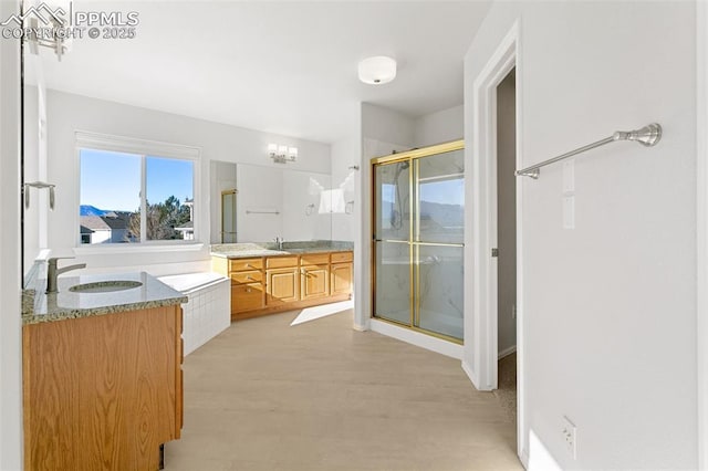 bathroom with independent shower and bath and vanity