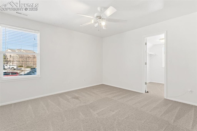 carpeted empty room with ceiling fan