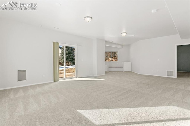 unfurnished living room featuring lofted ceiling and light carpet