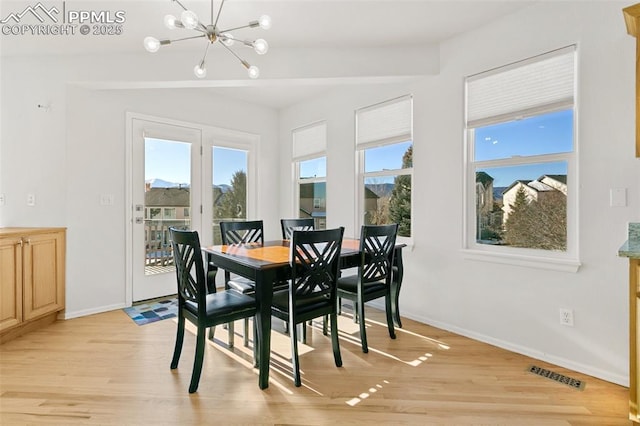 dining room featuring a notable chandelier and light hardwood / wood-style flooring