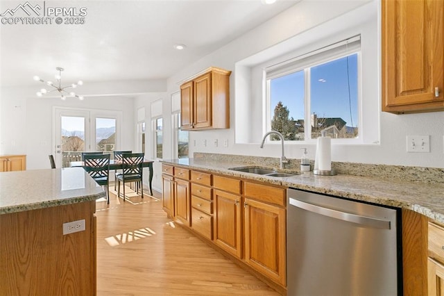 kitchen featuring dishwasher, a notable chandelier, light stone counters, sink, and light hardwood / wood-style flooring