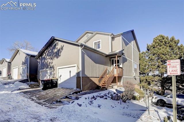 view of snowy exterior featuring a garage