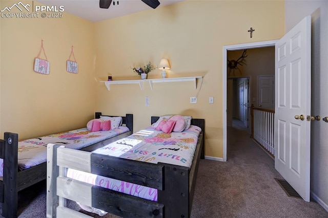 bedroom with dark colored carpet and ceiling fan