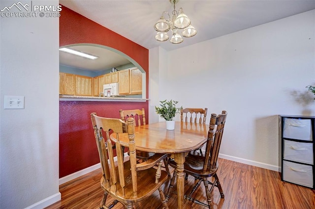 dining room featuring wood-type flooring and a notable chandelier