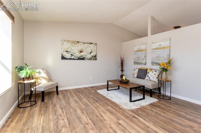 sitting room featuring hardwood / wood-style flooring and vaulted ceiling