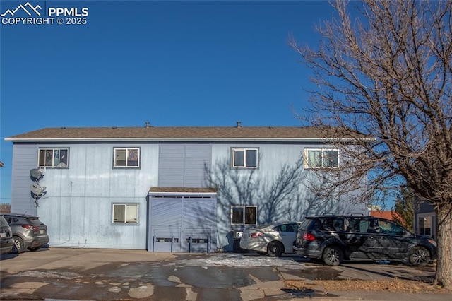 rear view of property with a garage