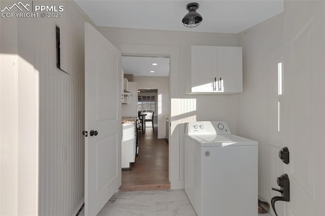 laundry area featuring cabinets and washer / dryer