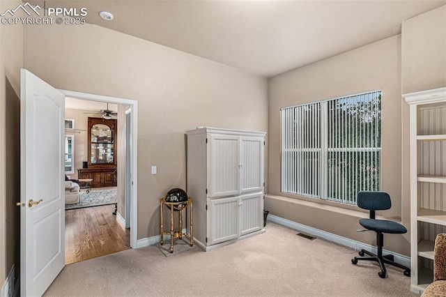 miscellaneous room featuring light carpet and ceiling fan