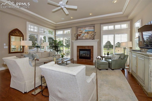 living room with crown molding, plenty of natural light, and light hardwood / wood-style floors