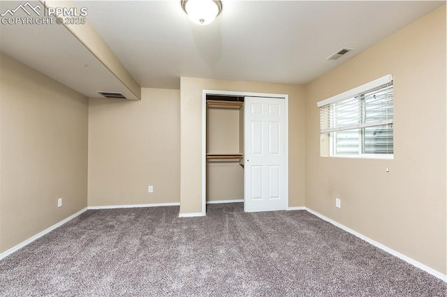 unfurnished bedroom featuring carpet flooring and a closet