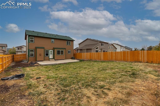 rear view of property with a yard and a patio