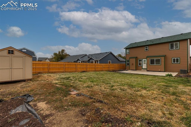 view of yard featuring a storage unit, cooling unit, and a patio area