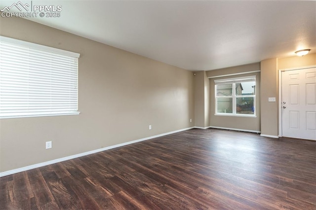 spare room featuring dark hardwood / wood-style flooring