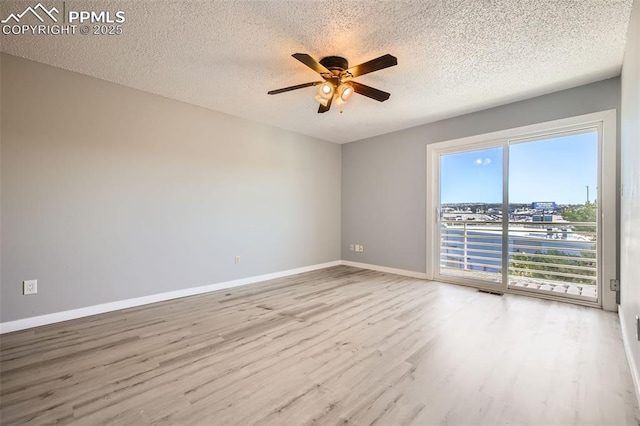 unfurnished room featuring ceiling fan, wood-type flooring, and a textured ceiling