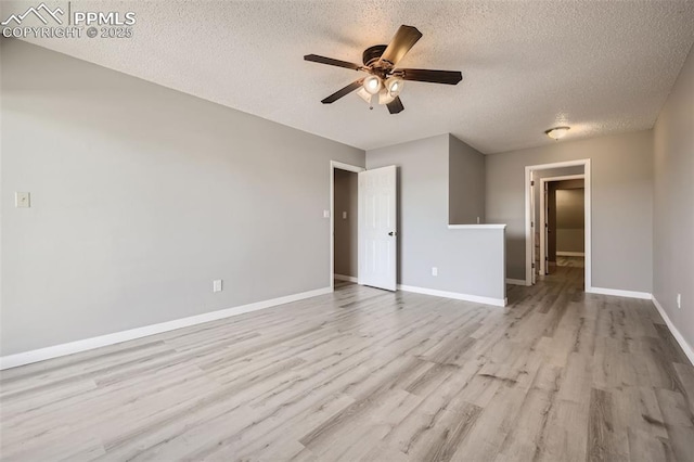 unfurnished room with ceiling fan, light hardwood / wood-style floors, and a textured ceiling