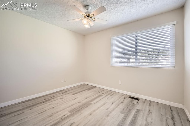 unfurnished room featuring ceiling fan, light hardwood / wood-style flooring, and a textured ceiling