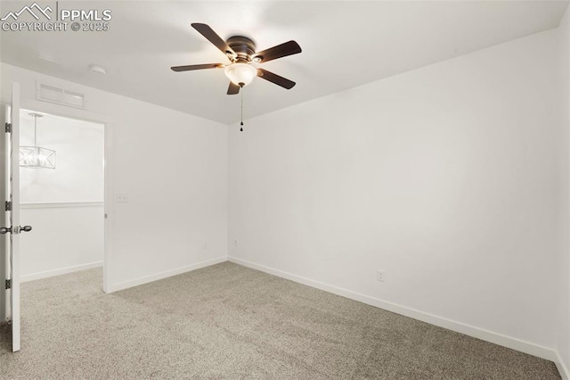 carpeted spare room featuring ceiling fan