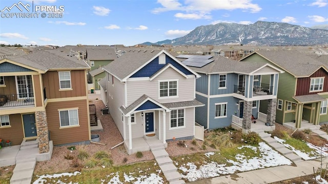 view of front of house featuring a mountain view and solar panels