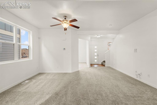 carpeted spare room featuring ceiling fan