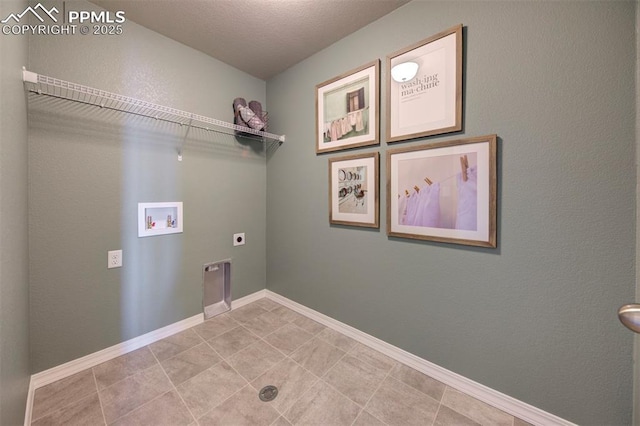 clothes washing area featuring washer hookup, electric dryer hookup, and a textured ceiling