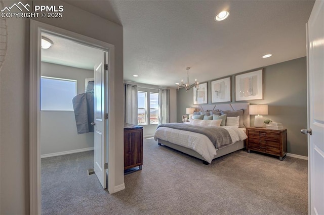 bedroom featuring carpet flooring and an inviting chandelier