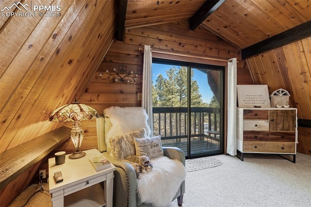 living area with wooden walls, lofted ceiling with beams, and carpet