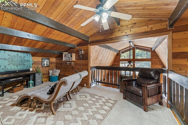 sitting room with wood walls, vaulted ceiling with beams, light colored carpet, ceiling fan, and wooden ceiling