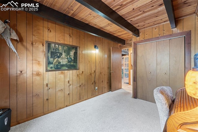 carpeted home office featuring wood ceiling, beam ceiling, and wooden walls