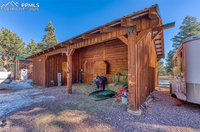 view of side of home featuring an outdoor structure