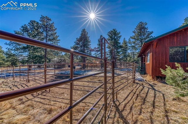 view of yard with an outdoor structure and a rural view