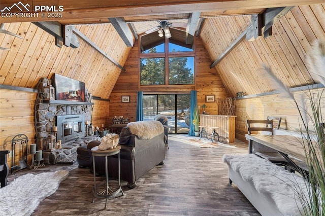 living room with beamed ceiling, wood-type flooring, and wood walls