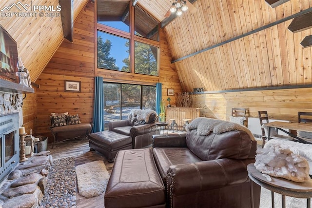 living room with beam ceiling, wooden walls, wooden ceiling, and a fireplace