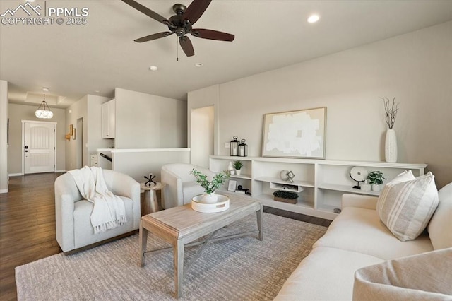 living room with ceiling fan and hardwood / wood-style flooring