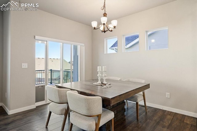 dining area featuring plenty of natural light, dark hardwood / wood-style floors, and an inviting chandelier