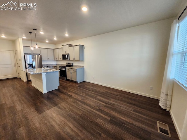 kitchen featuring pendant lighting, gray cabinetry, a center island, sink, and stainless steel appliances