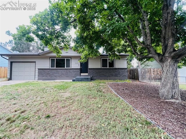 ranch-style home featuring a garage and a front lawn