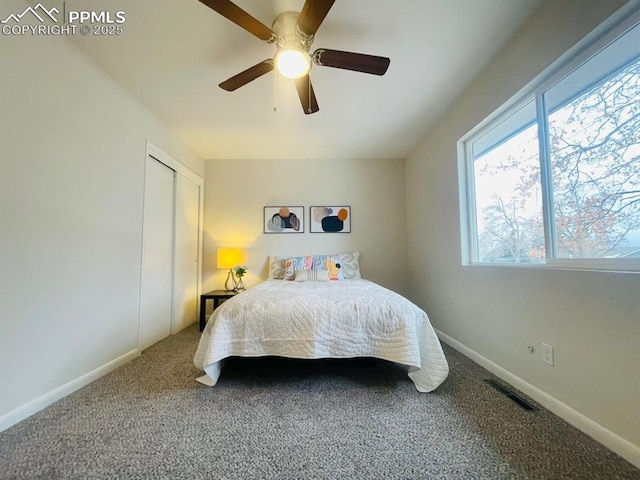 carpeted bedroom with ceiling fan and a closet