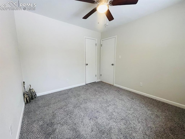 carpeted spare room with ceiling fan