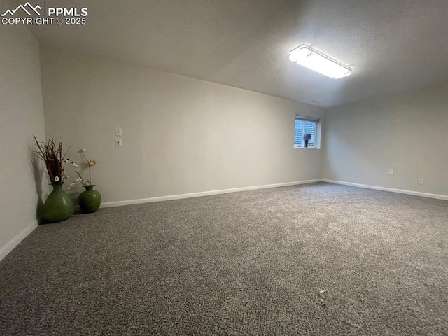 carpeted empty room featuring a textured ceiling