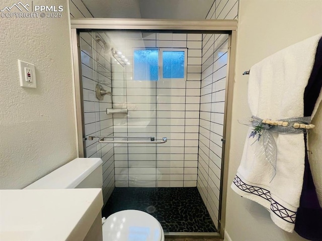 bathroom featuring toilet and walk in shower