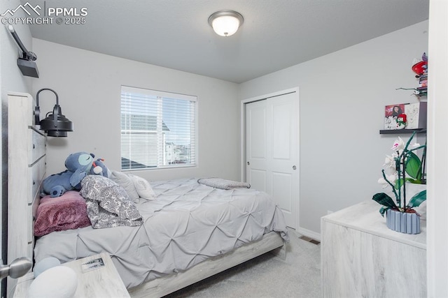 bedroom featuring light carpet and a closet