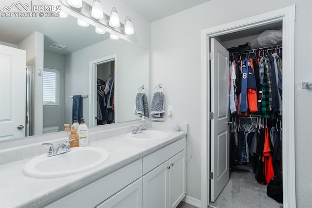 bathroom featuring vanity and toilet