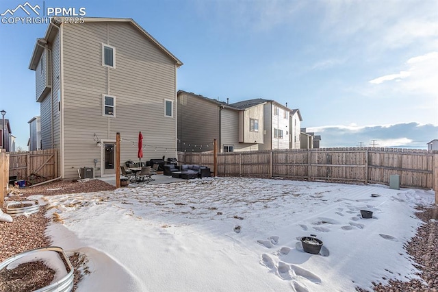 snow covered back of property featuring cooling unit and an outdoor hangout area