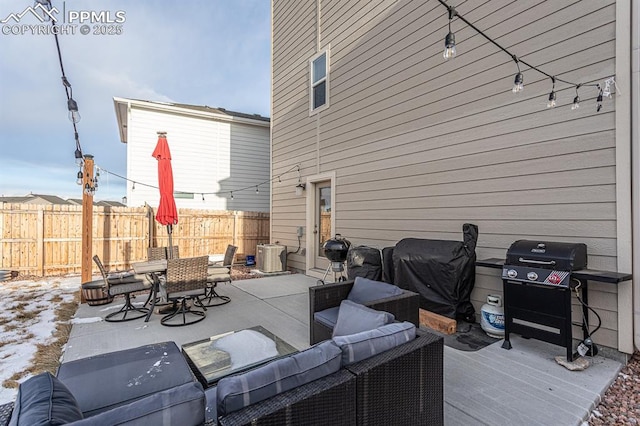 wooden terrace with grilling area, a patio area, and an outdoor hangout area