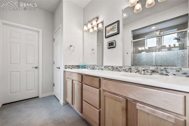 bathroom featuring tile patterned flooring, a shower with door, tasteful backsplash, and vanity