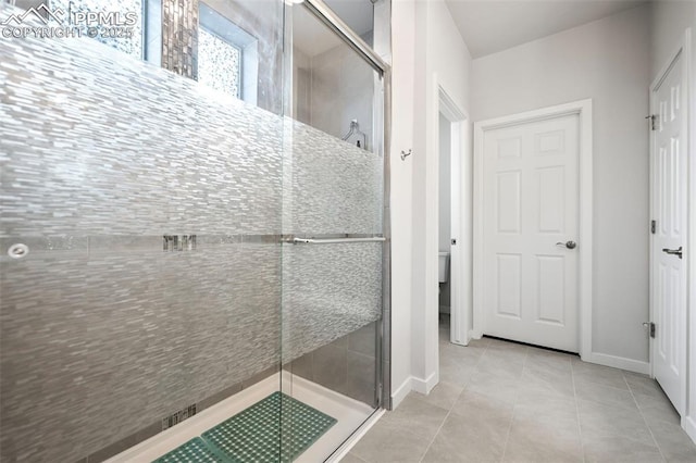 bathroom featuring walk in shower and tile patterned flooring