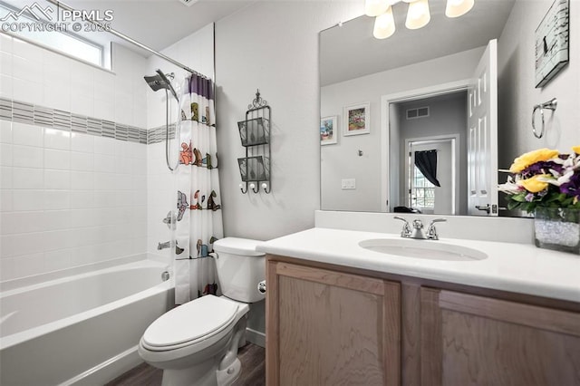 full bathroom with wood-type flooring, shower / tub combo, vanity, and toilet