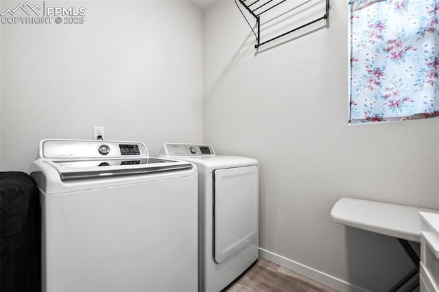 laundry area with washer and dryer and wood-type flooring